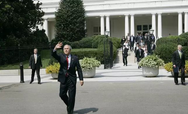 FILE - President Bush waves as walks away from the East Wing of the White House to the neighboring Treasury Building for the swearing-in of Treasury Secretary Henry Paulson, July 10, 2006 in Washington. At right is Chief of Staff Joshua Bolton. (AP Photo/Pablo Martinez Monsivais, File)