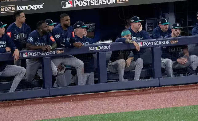 The Seattle Mariners watch from their dugout during the ninth inning in Game 7 of baseball's American League Championship Series against the Toronto Blue Jays, Monday, Oct. 20, 2025, in Toronto. (AP Photo/David J. Phillip)
