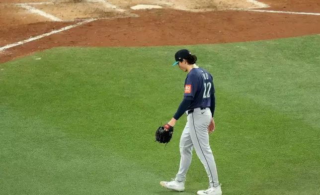 Seattle Mariners pitcher Bryan Woo walks back to the dugout after being pulled from the game during the seventh inning in Game 7 of baseball's American League Championship Series against the Toronto Blue Jays in Toronto, Monday, Oct. 20, 2025. (Chris Young/The Canadian Press via AP)