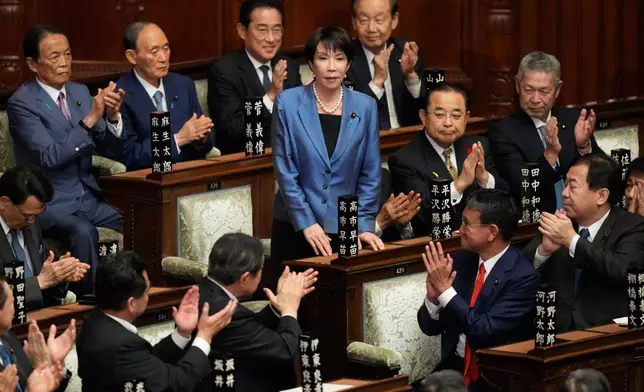 Lawmakers applaud as Sanae Takaichi, center, is elected as Japan's new prime minister during the extraordinary session of the lower house, in Tokyo, Japan, Tuesday, Oct. 21, 2025.(AP Photo/Eugene Hoshiko)