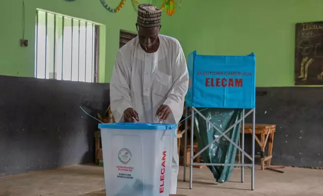 A man casts his ballot at a polling station during the presidential election in Garoua, Cameroon, Sunday, Oct. 12, 2025.(AP Photo/Welba Yamo Pascal)