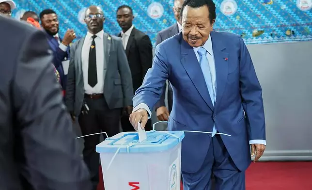 President Paul Biya casts his ballot at the Government Bilingual primary school Bastos in Yaounde, Cameroon, Saturday, Oct. 12, 2025 (AP Photo/Angel Ngwe)