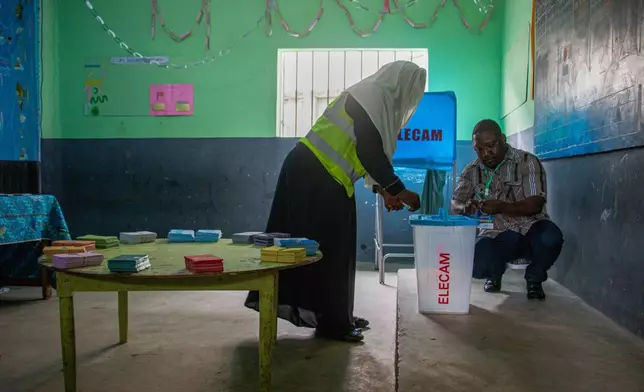 Election officials set up ballot materials before the start of voting at a polling station in Garoua, Cameroon, Sunday, Oct. 12, 2025.(AP Photo/Welba Yamo Pascal)