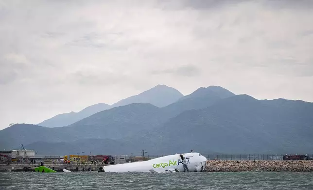 The cargo aircraft that skidded off a Hong Kong airport runway is seen on Monday, Oct. 20, 2025. (AP Photo/Chan Long Hei)