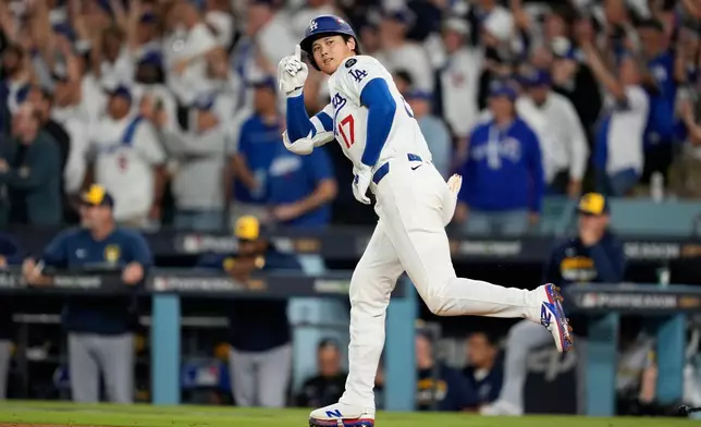 Los Angeles Dodgers' Shohei Ohtani celebrates his home run against the Milwaukee Brewers during the seventh inning in Game 4 of baseball's National League Championship Series, Friday, Oct. 17, 2025, in Los Angeles. (AP Photo/Ashley Landis)