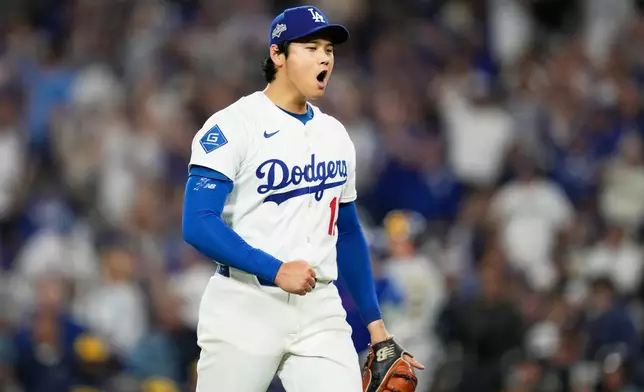 Los Angeles Dodgers pitcher Shohei Ohtani celebrates the end of the top of the third inning against the Milwaukee Brewers in Game 4 of baseball's National League Championship Series, Friday, Oct. 17, 2025, in Los Angeles. (AP Photo/Ashley Landis)