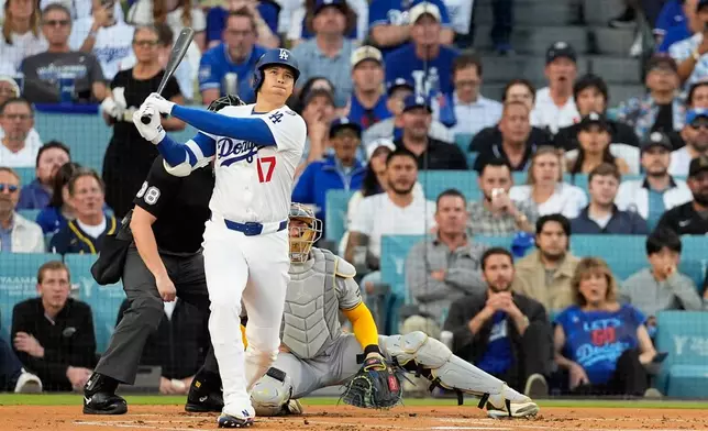 Los Angeles Dodgers' Shohei Ohtani watches his home run against the Milwaukee Brewers during the first inning in Game 4 of baseball's National League Championship Series, Friday, Oct. 17, 2025, in Los Angeles. (AP Photo/Mark J. Terrill)