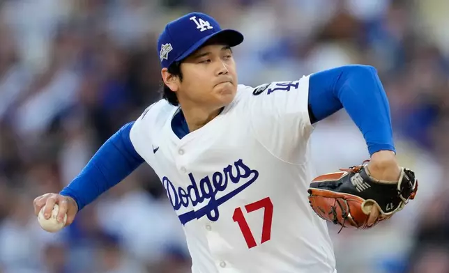 Los Angeles Dodgers pitcher Shohei Ohtani throws against the Milwaukee Brewers during the first inning in Game 4 of baseball's National League Championship Series, Friday, Oct. 17, 2025, in Los Angeles. (AP Photo/Ashley Landis)