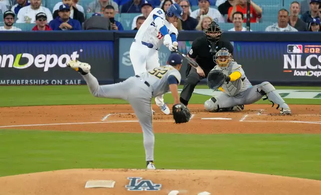 Los Angeles Dodgers' Shohei Ohtani hits a home run against the Milwaukee Brewers during the first inning in Game 4 of baseball's National League Championship Series, Friday, Oct. 17, 2025, in Los Angeles. (AP Photo/Mark J. Terrill)
