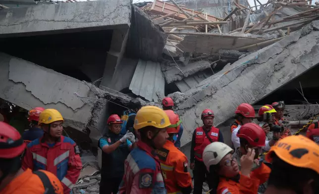 Rescuers search for victims at the site where a building under construction collapsed at an Islamic boarding school in Sidoarjo, East Java, Indonesia, Tuesday, Sept. 30, 2025. (AP Photo/Trisnadi)