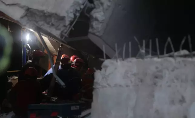 Rescuers search for victims at the site where a building under construction collapsed at an Islamic boarding school in Sidoarjo, East Java, Indonesia, Tuesday, Sept. 30, 2025. (AP Photo/Trisnadi)