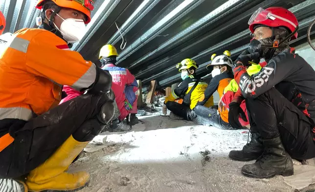 Rescuers search for victims trapped under the rubble after a building collapsed at an Islamic boarding school in Sidoarjo, East Java, Indonesia, Wednesday, Oct. 1, 2025. (AP Photo/Trisnadi)