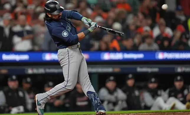 Seattle Mariners' Eugenio Suárez hits a solo home run during the fourth inning in Game 3 of baseball's American League Division Series against the Detroit Tigers Tuesday, Oct. 7, 2025, in Detroit. (AP Photo/Paul Sancya)