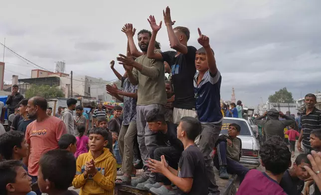 Palestinians celebrate following the announcement that Israel and Hamas have agreed to the first phase of a peace plan to pause the fighting, in Khan Younis, southern Gaza Strip, Thursday, Oct. 9, 2025. Celebrations remain limited, as relief is mixed with mourning and concern for what comes next. (AP Photo/Jehad Alshrafi)