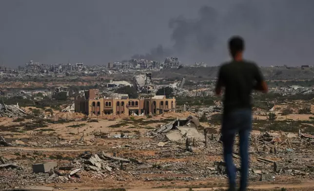Smoke rises following an Israeli military strike in Gaza City as seen from the central Gaza Strip, Wednesday, Oct. 8, 2025. (AP Photo/Abdel Kareem Hana)