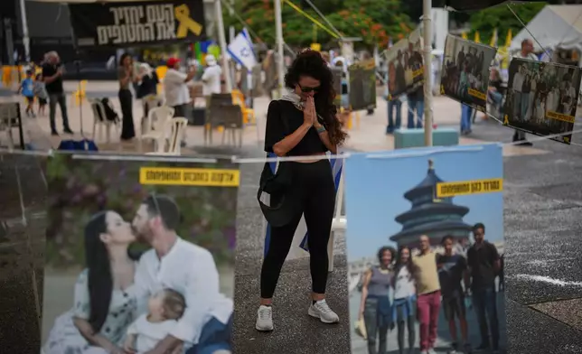 Ofir Kimchi prays as relatives and supporters of Israeli hostages held by Hamas in the Gaza Strip celebrate following the announcement that Israel and Hamas have agreed to the first phase of a peace plan to pause the fighting, at a plaza known as hostages square in Tel Aviv, Israel, Thursday, Oct. 9, 2025. (AP Photo/Emilio Morenatti)
