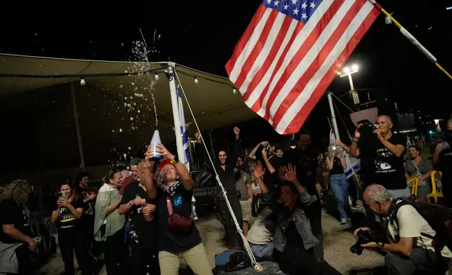 Relatives and supporters of Israeli hostages held by Hamas in the Gaza Strip celebrate after the announcement that Israel and Hamas have agreed to the first phase of a peace plan, as they gather at a plaza known as the hostages square in Tel Aviv, Israel, Thursday, Oct. 9, 2025. (AP Photo/Ohad Zwigenberg)