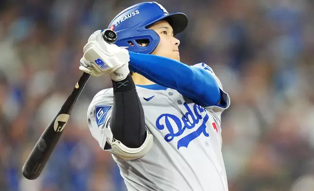 Los Angeles Dodgers' Shohei Ohtani hits a two-run home run against the Toronto Blue Jays during the seventh inning of Game 1 of baseball's World Series in Toronto, Friday, Oct. 24, 2025. (Frank Gunn/The Canadian Press via AP)