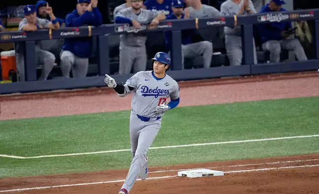 Los Angeles Dodgers' Shohei Ohtani rounds the bases after hitting a two run home run against the Toronto Blue Jays during the seventh inning in Game 1 of baseball's World Series, Friday, Oct. 24, 2025, in Toronto. (AP Photo/David J. Phillip)