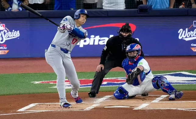 Los Angeles Dodgers' Shohei Ohtani strikes out during the first inning in Game 1 of baseball's World Series against the Toronto Blue Jays, Friday, Oct. 24, 2025, in Toronto. (AP Photo/David J. Phillip)