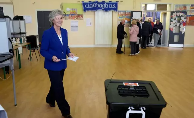 Independent candidate Catherine Connolly casts her vote in the election for the next Irish president at Claddagh National School in Galway city, Ireland, Friday, Oct. 24, 2025. (Brian Lawless/PA via AP)