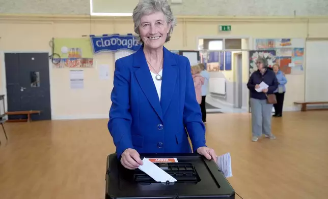 Independent candidate Catherine Connolly casts her vote in the election for the next Irish president at Claddagh National School in Galway city, Ireland, Friday, Oct. 24, 2025. (Brian Lawless/PA via AP)