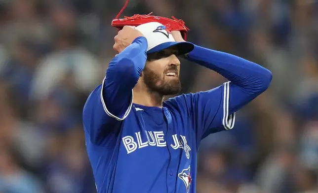Toronto Blue Jays pitcher Kevin Gausman reacts after giving up a home run to Seattle Mariners' Cal Raleigh during the sixth inning in Game 1 of baseball's American League Championship Series in Toronto, Sunday, Oct. 12, 2025. (Chris Young/The Canadian Press via AP)