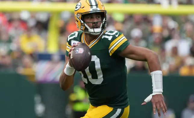 Green Bay Packers quarterback Jordan Love (10) runs out of the pocket against the Cincinnati Bengals in the first half of an NFL football game, Sunday, Oct. 12, 2025, in Green Bay, Wis. (AP Photo/Morry Gash)