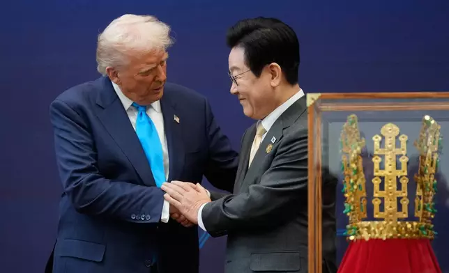 President Donald Trump shakes hands with South Korean President Lee Jae Myung as they attend a high honor ceremony at the Gyeongju National Museum in Gyoeongju, South Korea, Wednesday, Oct. 29, 2025. (AP Photo/Mark Schiefelbein)