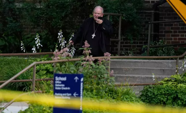 FILE - The archbishop of Saint Paul and Minneapolis, Bernard Hebda talks on the phone outside the Annunciation Church's school after shooting, Wednesday, Aug. 27, 2025, in Minneapolis. (AP Photo/Abbie Parr, File)