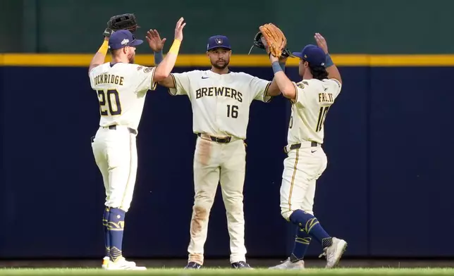 Milwaukee Brewers players, from left, Brandon Lockridge, Blake Perkins and Sal Frelick celebrate defeating the Chicago Cubs 9-3 in Game 1 of baseball's National League Division Series, Saturday, Oct. 4, 2025, in Milwaukee. (AP Photo/Kayla Wolf)