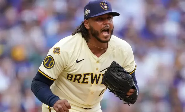 Milwaukee Brewers pitcher Freddy Peralta (51) reacts to striking out a batter during the fifth inning in Game 1 of baseball's National League Division Series against the Chicago Cubs on Saturday, Oct. 4, 2025, in Milwaukee. (AP Photo/Kayla Wolf)