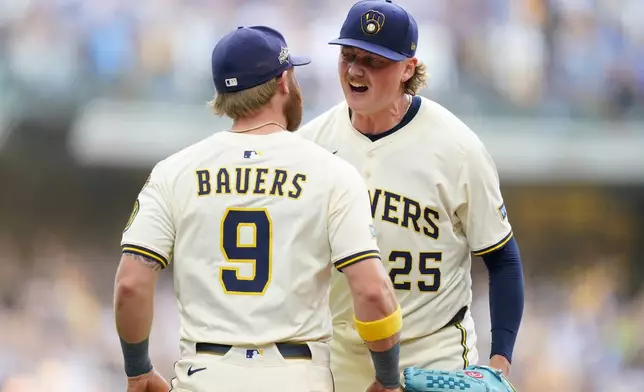 Milwaukee Brewers pitcher Nick Mears (25) celebrates with Jake Bauers (9) after defeating the Chicago Cubs 9-3 in Game 1 of baseball's National League Division Series, Saturday, Oct. 4, 2025, in Milwaukee. (AP Photo/Kayla Wolf)