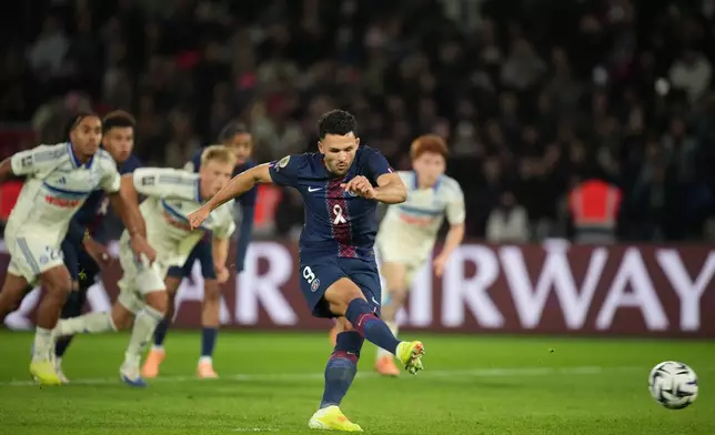 PSG's Goncalo Ramos scores his side's second goal by a penalty during the French League One soccer match between Paris Saint-Germain and Strasbourg, in Paris, France, Friday, Oct. 17, 2025. (AP Photo/Christophe Ena)