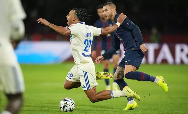 PSG's Lucas Hernandez, right, and Strasbourg's Guela Doue challenge for the ball during the French League One soccer match between Paris Saint-Germain and Strasbourg, in Paris, France, Friday, Oct. 17, 2025. (AP Photo/Christophe Ena)