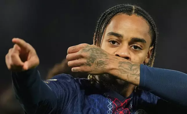 PSG's Bradley Barcola celebrates after scoring the opening goal during the French League One soccer match between Paris Saint-Germain and Strasbourg, in Paris, France, Friday, Oct. 17, 2025. (AP Photo/Christophe Ena)