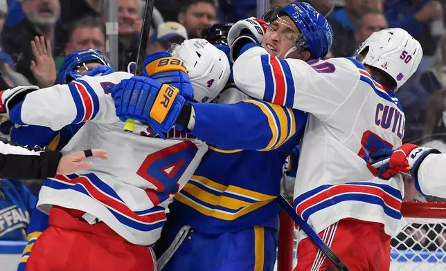 Buffalo Sabres center Tage Thompson, second from right, is held by New York Rangers left wing Will Cuylle (50) as players scuffle after the whistle during the second period of an NHL hockey game in Buffalo, N.Y., Thursday, Oct. 9, 2025. (AP Photo/Adrian Kraus)