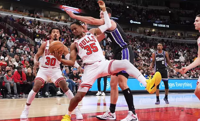 Chicago Bulls forward/guard Isaac Okoro (35) rebounds a ball against Sacramento Kings forward/center Drew Eubanks (19) during the first half of an NBA basketball game in Chicago, Wednesday, Oct. 29, 2025. (AP Photo/Nam Y. Huh)