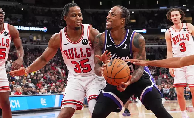 Sacramento Kings forward Demar Derozan, right, drives as Chicago Bulls forward Isaac Okoro guards during the first half of an NBA basketball game in Chicago, Wednesday, Oct. 29, 2025. (AP Photo/Nam Y. Huh)