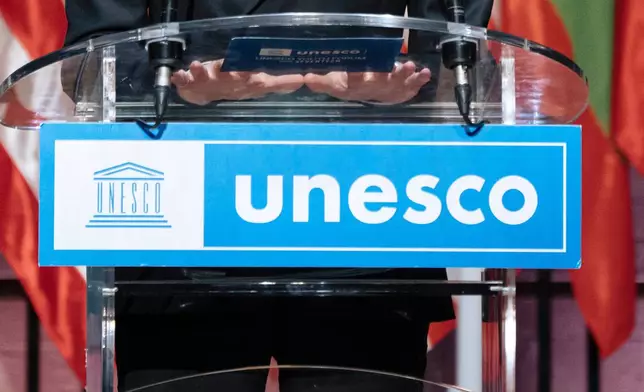 FILE - The UNESCO logo hangs from a podium in Paris, Nov. 14, 2023. (AP Photo/Lewis Joly, File)