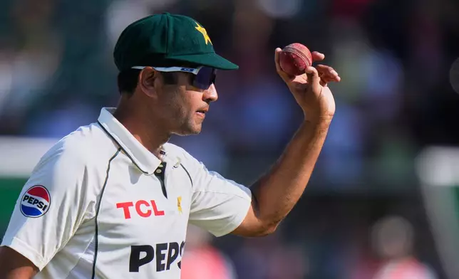 Pakistan's Asif Afridi, who took six wickets, displays the ball as he walk off the field on the end of South African first innings during the third day of the second test cricket match between Pakistan and South Africa, in Rawalpindi, Pakistan, Wednesday, Oct. 22, 2025. (AP Photo/Anjum Naveed)