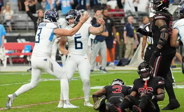 Tennessee Titans punter Johnny Hekker (3) congratulates place-kicker Joey Slye (6) after making a game winning field goal during the second half of an NFL football game against the Arizona Cardinals, Sunday, Oct. 5, 2025, in Glendale, Ariz. (AP Photo/Ross D. Franklin)