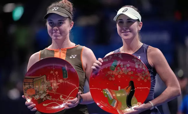 Switzerland's Belinda Bencic, right, and Czech Republic's Linda Noskova, left, pose with their trophies after the Pan Pacific Open women's tennis tournament at Ariake Coliseum, in Tokyo, Sunday, Oct. 26, 2025. (AP Photo/Louise Delmotte)