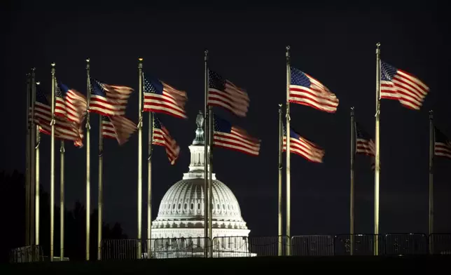 The dome of the U.S. Capitol is seen before dawn on Wednesday, Oct. 1, 2025, in Washington. (AP Photo/Mark Schiefelbein)