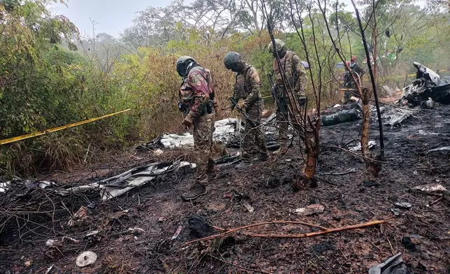 Kenyan officials inspect the scene of a plane crash near Diani, Kenya, Tuesday, Oct. 28, 2025. (AP Photo)