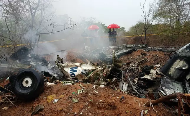 Kenyan officials inspect the scene of a plane crash near Diani, Kenya, Tuesday, Oct. 28, 2025. (AP Photo)