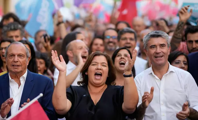 Alexandra Leitao, leader of the left-of-center coalition Viver Lisboa, or To Live Lisbon, claps her hands during a campaign action in downtown Lisbon ahead of Sunday's municipal elections, Friday, Oct. 10, 2025. (AP Photo/Armando Franca)