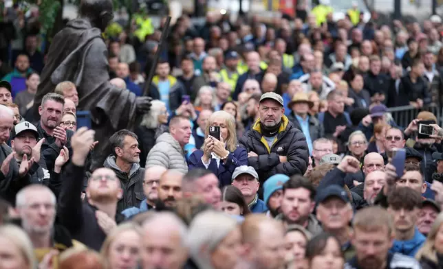 Crowds gather outside Manchester Cathedral during the funeral for boxer Ricky Hatton in Manchester, England, Friday, Oct. 10, 2025. (AP Photo/Jon Super)