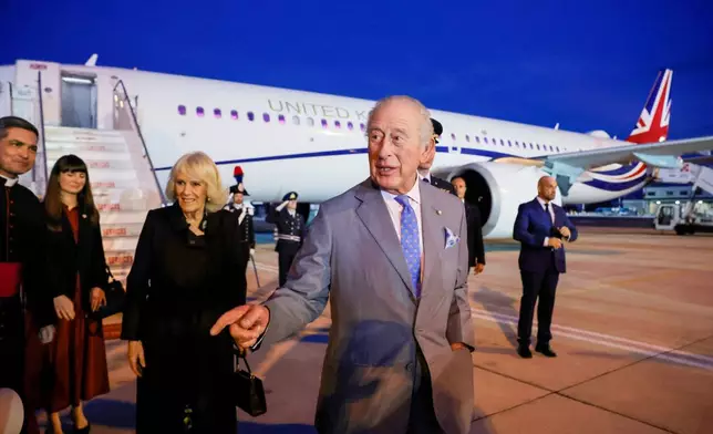Britain's King Charles III and Queen Camilla arrive at Ciampino 31st Wing Airport in the outskirts of Rome, Wednesday, Oct. 22, 2025, a day before their state visit to the Vatican. (Cecilia Fabiano/ Lapresse via AP)