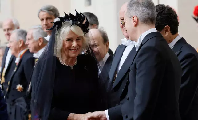 Britain's Queen Camilla arrives with King Charles III in the St. Damasus Courtyard at the Vatican for a state visit, where they will meet with Pope Leo XIV and pray with him in the Sistine Chapel, Thursday, Oct. 23, 2025. (Cecilia Fabiano/LaPresse via AP)